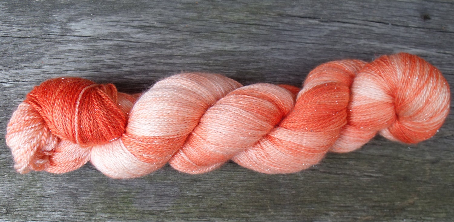 Extra Fine Merino, Silk and Silver Stellina Sparkle Laceweight yarn handpainted in shades of rust and peach