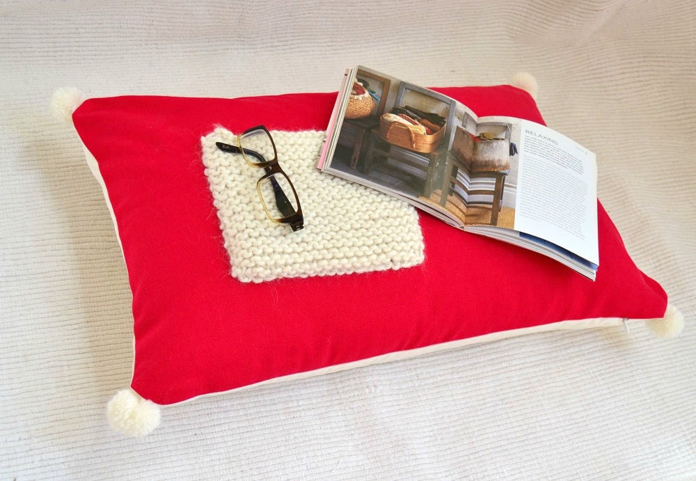 Red cotton lumbar pillow cover with wool pocket .