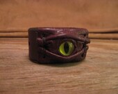 Grichels leather wrist cuff/bracelet - textured brown with custom metallic lime green glitter slit pupil eye