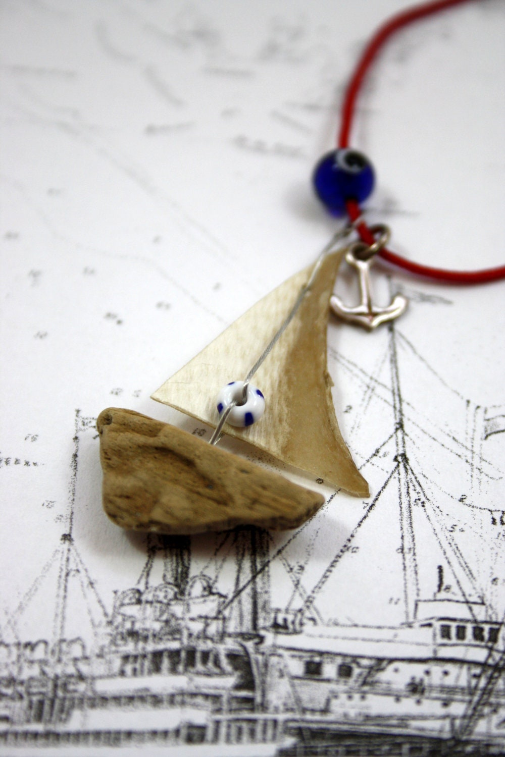 driftwood sailboat necklace with sail from genuine parchment , it has an anchor from sterling silver and a life ring......"ship ahoy" - Yalos