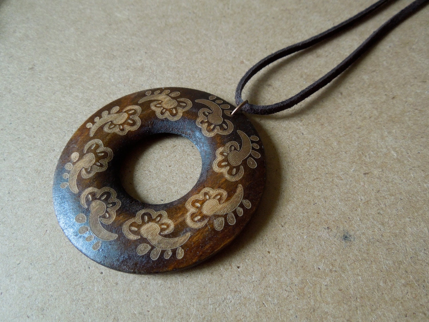 Large wooden circle pendant with swirly design
