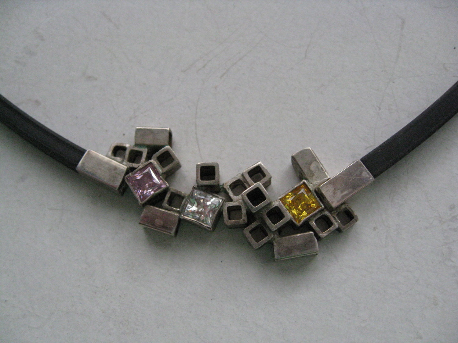 Square Necklace of black rubber, silver and quarts stones.