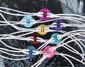 Cute as a button bracelet in SHINY colors.