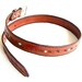 Leather belt with turquoise and silver bead inlay and barbed wire motif.