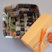 Colorful handwoven paper basket with lid crafted from upcycled paper