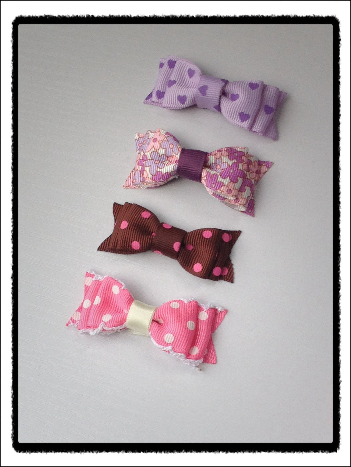 Small double bow hair clip set.  Purple and pink tones
