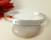 Hunger Games Jewelry - Hand stamped Real or not real, real