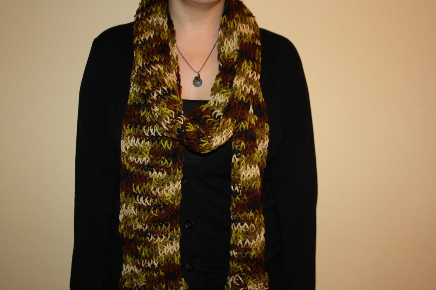 Hand knit brown, green, beige, and black scarf with fringe