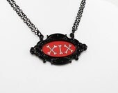 Dem Bones - A cute hand drawn necklace in a little black metal frame jewelry