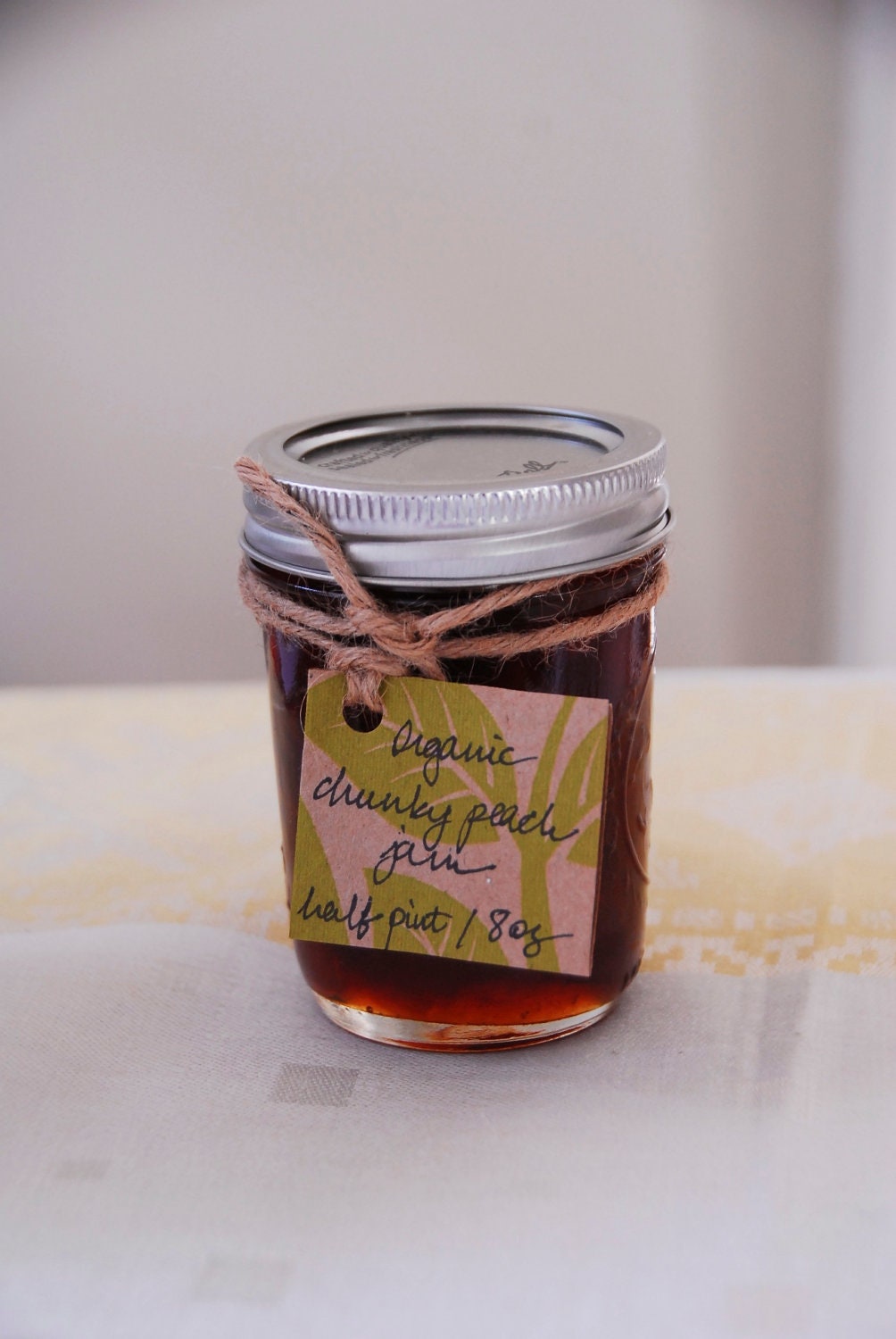 8 oz (half pint) jar of thick and chunky organic peach jam with fair trade sugar