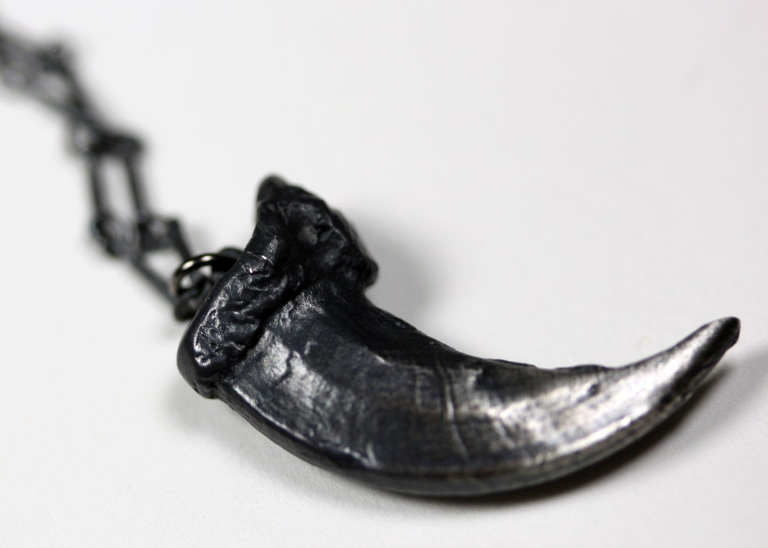the one you feed. sterling wolf claw necklace.