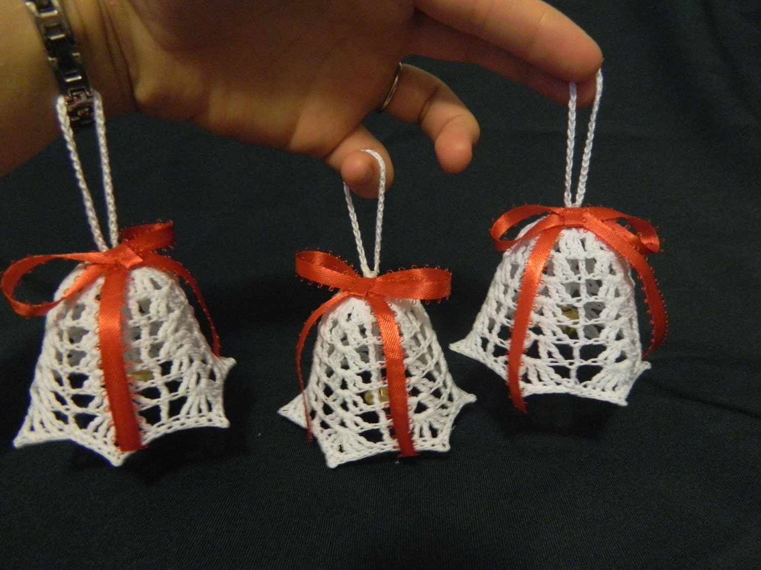 3 White hand crocheted 3-D Christmas tree bell ornaments with a red bow on top
