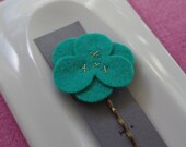 Jade green wool felt flower hair clip with gold stitching