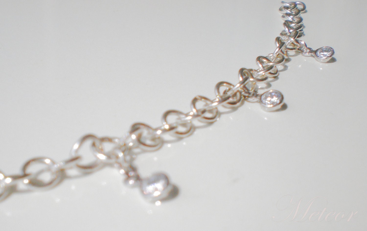 Silver plated copper chain bracelet with colorless zircons