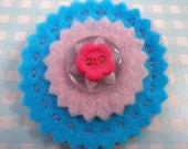 Pale pink and turquoise round felt brooch with button detail