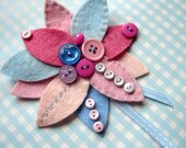 Pink and blue felt flower corsage with button decoration and ribbon trim