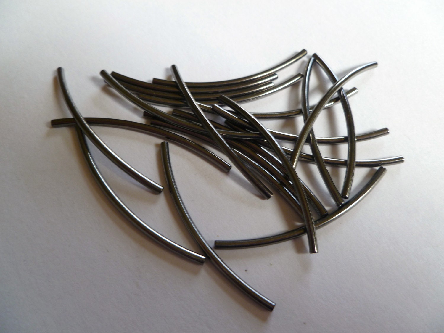 Bead, gunmetal-plated brass, 45x2mm curved tube. Sold per pkg of 20.
