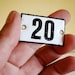 vintage enamel number 25 from Germany, likely used for hotel or apartments, black on white