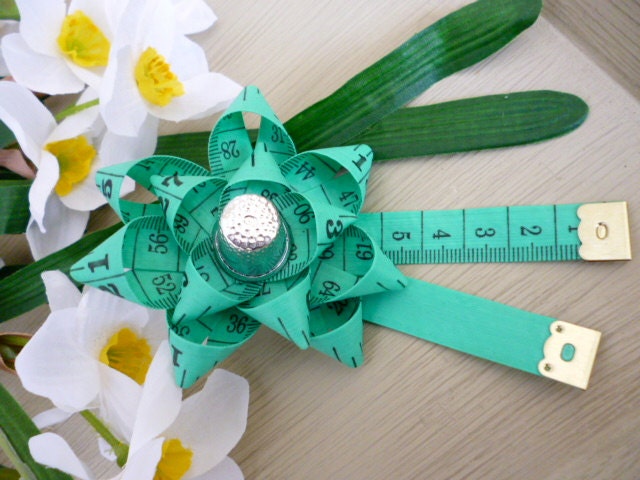 measuring tape brooch with sewing notions