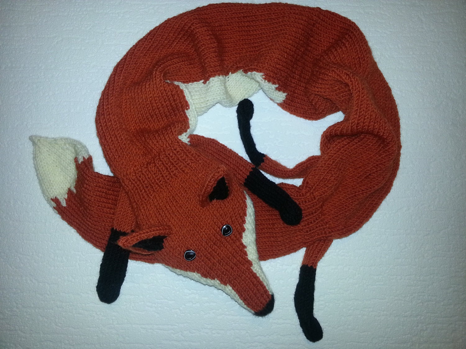 Hand-knitted reddish orange fox scarf