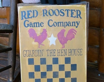 Red Rooster Game Company checkerboard sign in mustard barn red and black