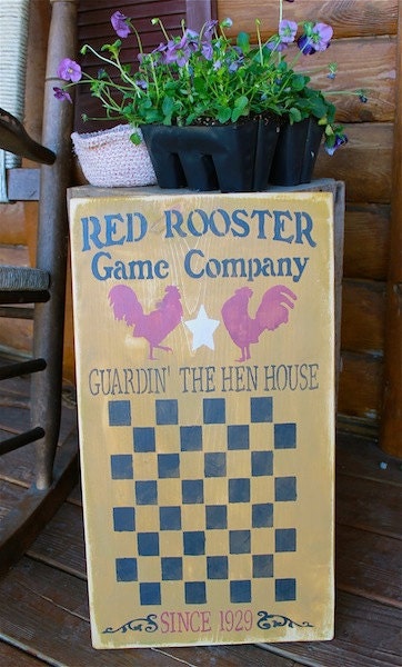 Red Rooster Game Company checkerboard sign in mustard barn red and black