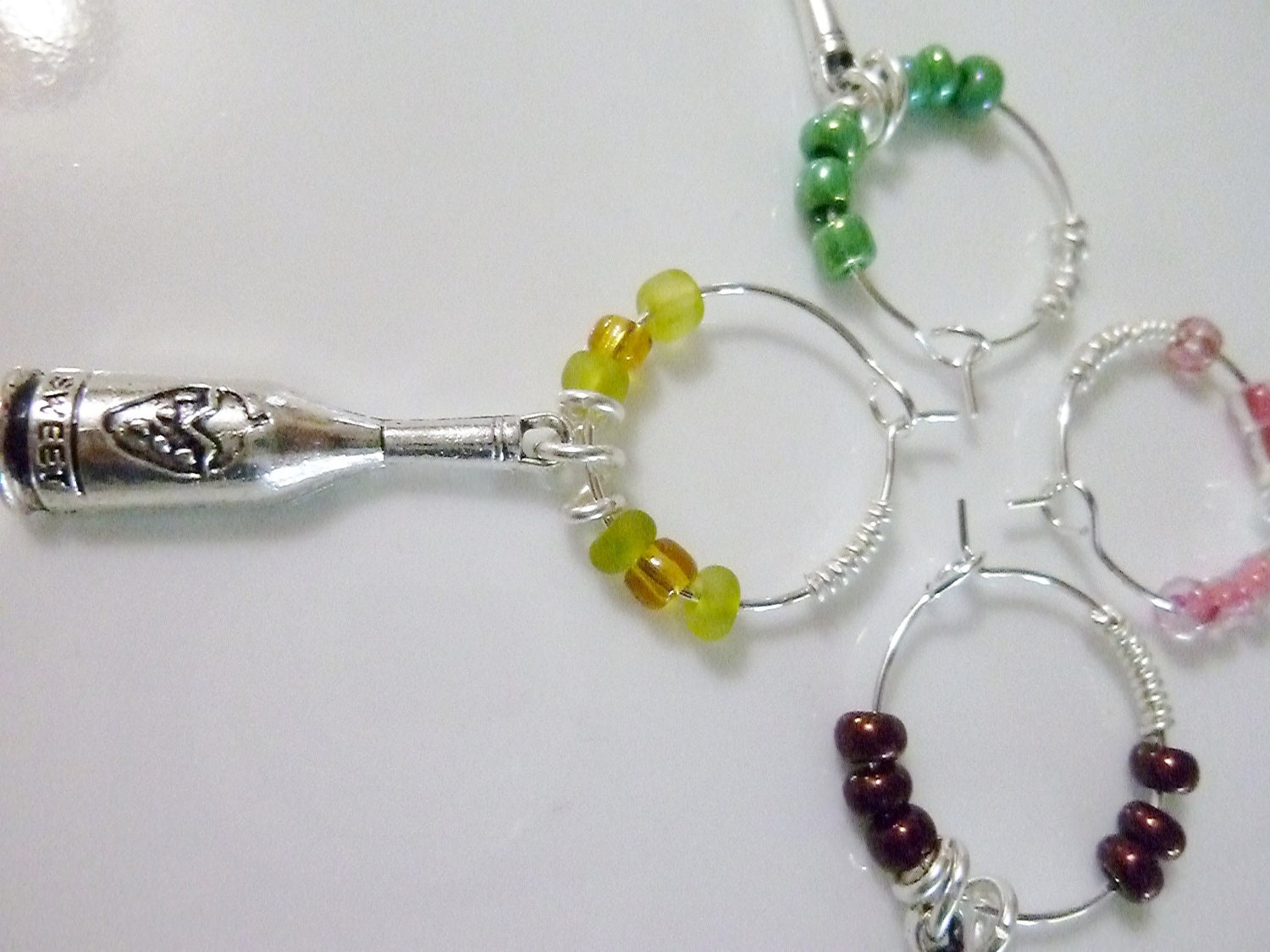 Set of 4 beaded Wine Bottle Charms in pink, maroon, yellow and green
