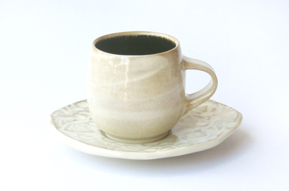 Coffee cup with leaf shaped saucer & white flannel flower design
