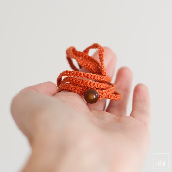Crochet Bracelet . Orange with brown button .