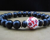 Chakra Energy Bracelet - First Chakra - Black Onyx, Czech Jet, Antique Gold Spacers, & Ceramic Bead with Red/Pink Blossoms - by We Are 1