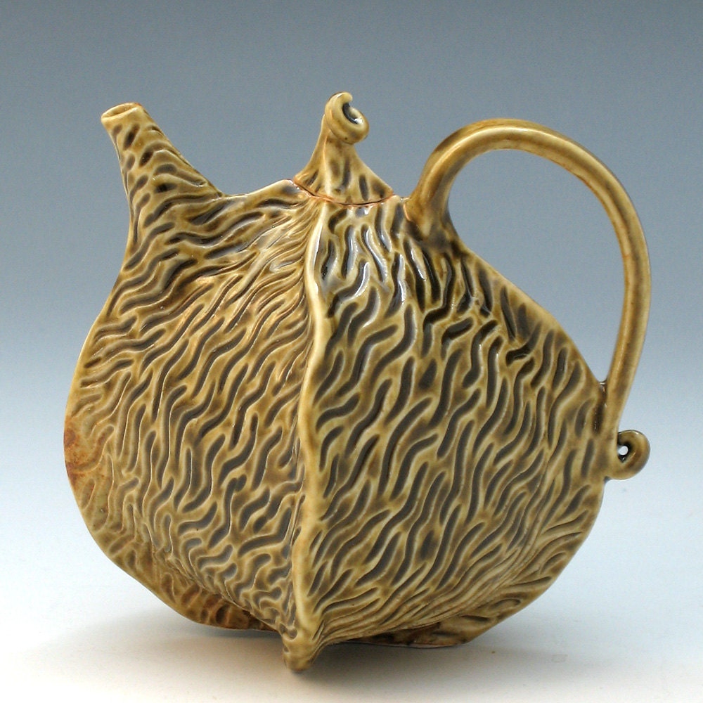 Carved porcelain teapot in olive green celadon