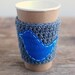 Coffee sleeve, gray with blue bird by The Cozy Project