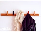 Custom made wooden coat rack in Oak. Movable pins. Can be customized to fit every room of the house.
