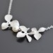 Three Orchid flower and pearl white gold plated necklace.