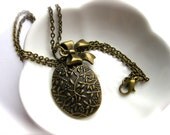 Shabby Chic Antique Gold Flowered Locket Necklace-With a Bow Charm-Pop of Color Inside-Winter Fashion-Springtime Jewelry-Easter Egg Pendant