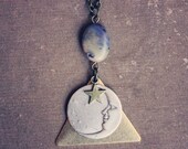 celeste. a magical moon and star brass triangle necklace.