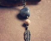 joyce.  a simple earthy beaded and feather charm necklace.