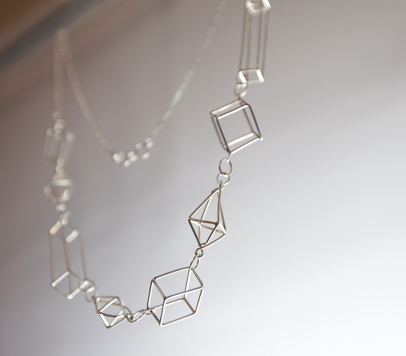 The big fancy, unique handmade sterling silver 3d geometric necklace.  Extra long, diamonds, rectangles, and cubes