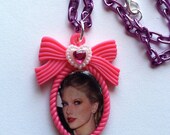 CUTE Taylor Swift Necklace on a pink bow cameo, purple aluminum chain, white heart with pink crystal. the best day, white horse, love story