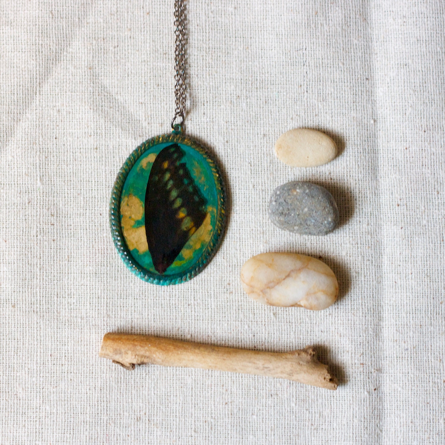 real butterfly wing necklace on green verdigris patina filigree bezel. black gold green. studiobotanica.