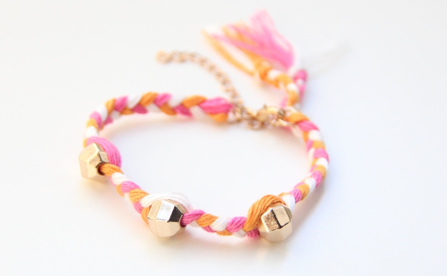 ON SALE: Arm candy - Golden beads on Pink White and Orange braid - woven bracelet
