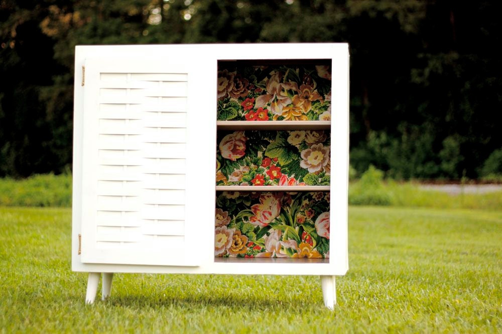 White One-Door Mid Century Cabinet with Taupe Shelves and Floral Upholstered Back