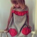 Girls dress with red polka dot pockets and front detail.