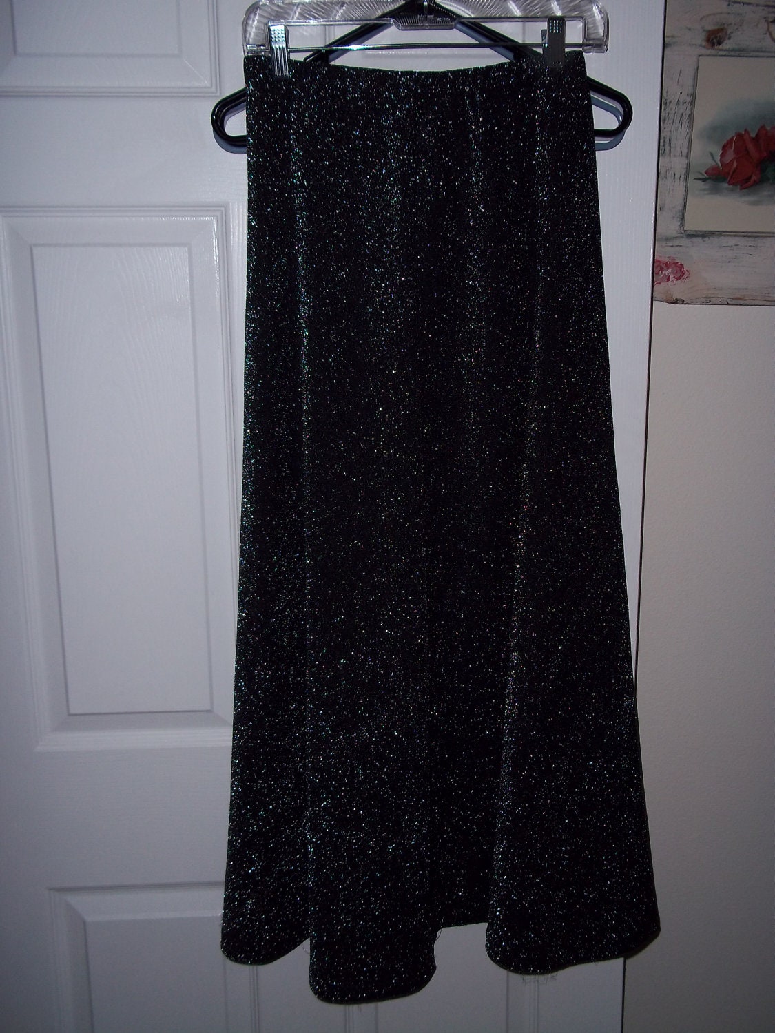 Ladies long black skirt with silver iridescent threads throughout. Very disco. see through. cool