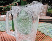 Vintage glass pitcher with white spaghetti drizzle pattern