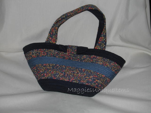 Navy blue and blue floral handmade purse that is lined and has hook and loop closure