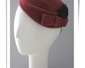 Dusty rose felt pillbox with feathers and felt bow