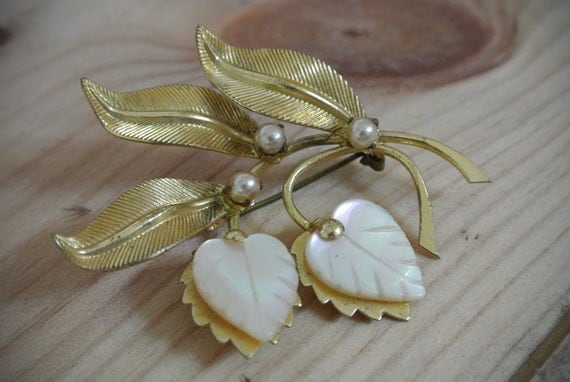 Gold botanical brooch with mother of pearl featured image