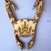 Patterned Loki helmet necklace.