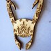 Patterned Loki helmet necklace.